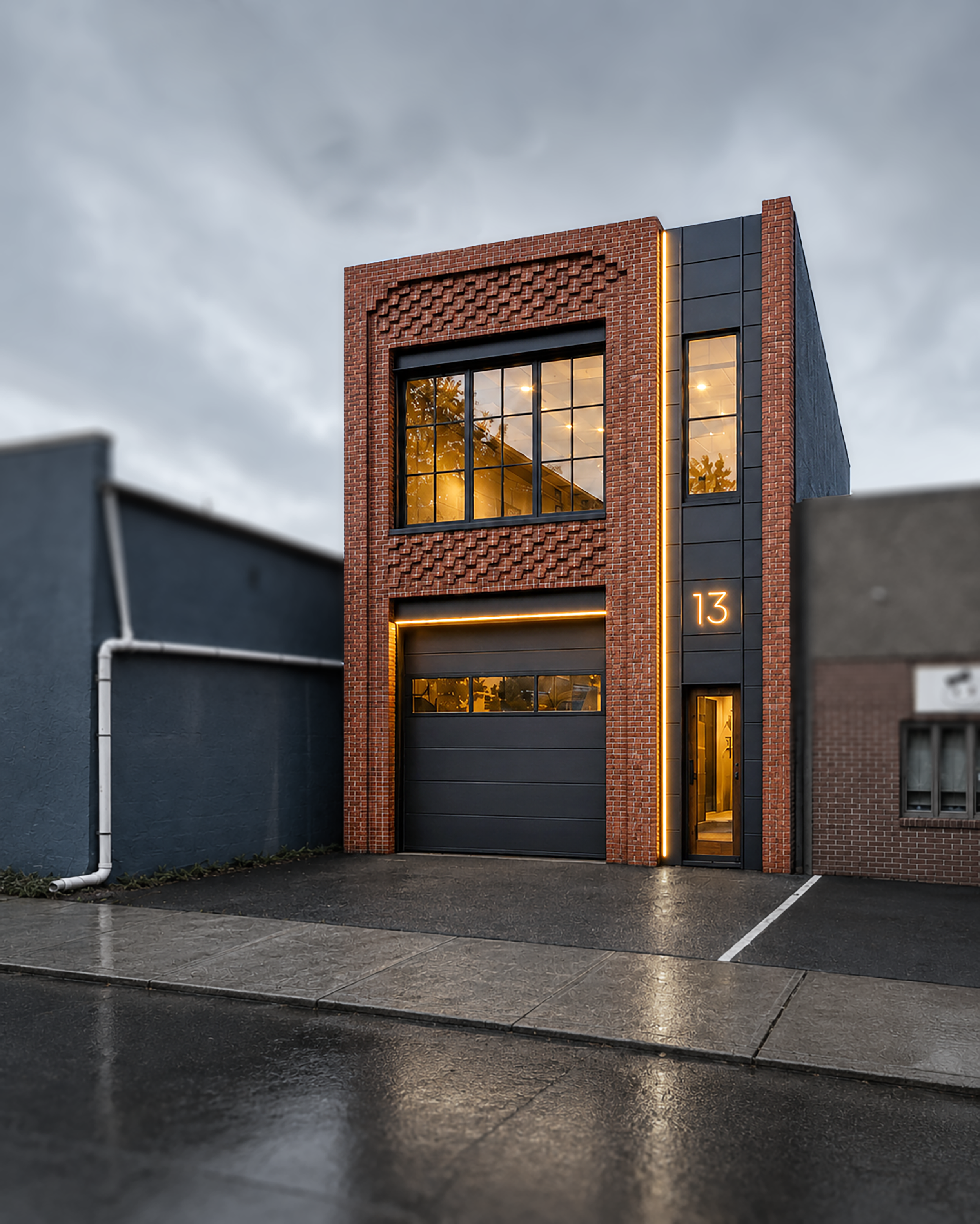 Brick and black metal facade at 13 Arlington illuminated at dusk
